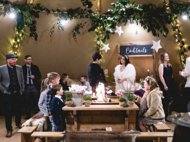 The Woodlands tipi interior at Christmas with guests