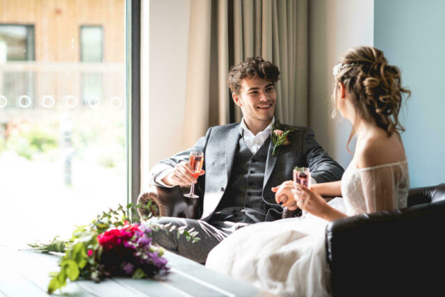 Happy couple sat together with drinks