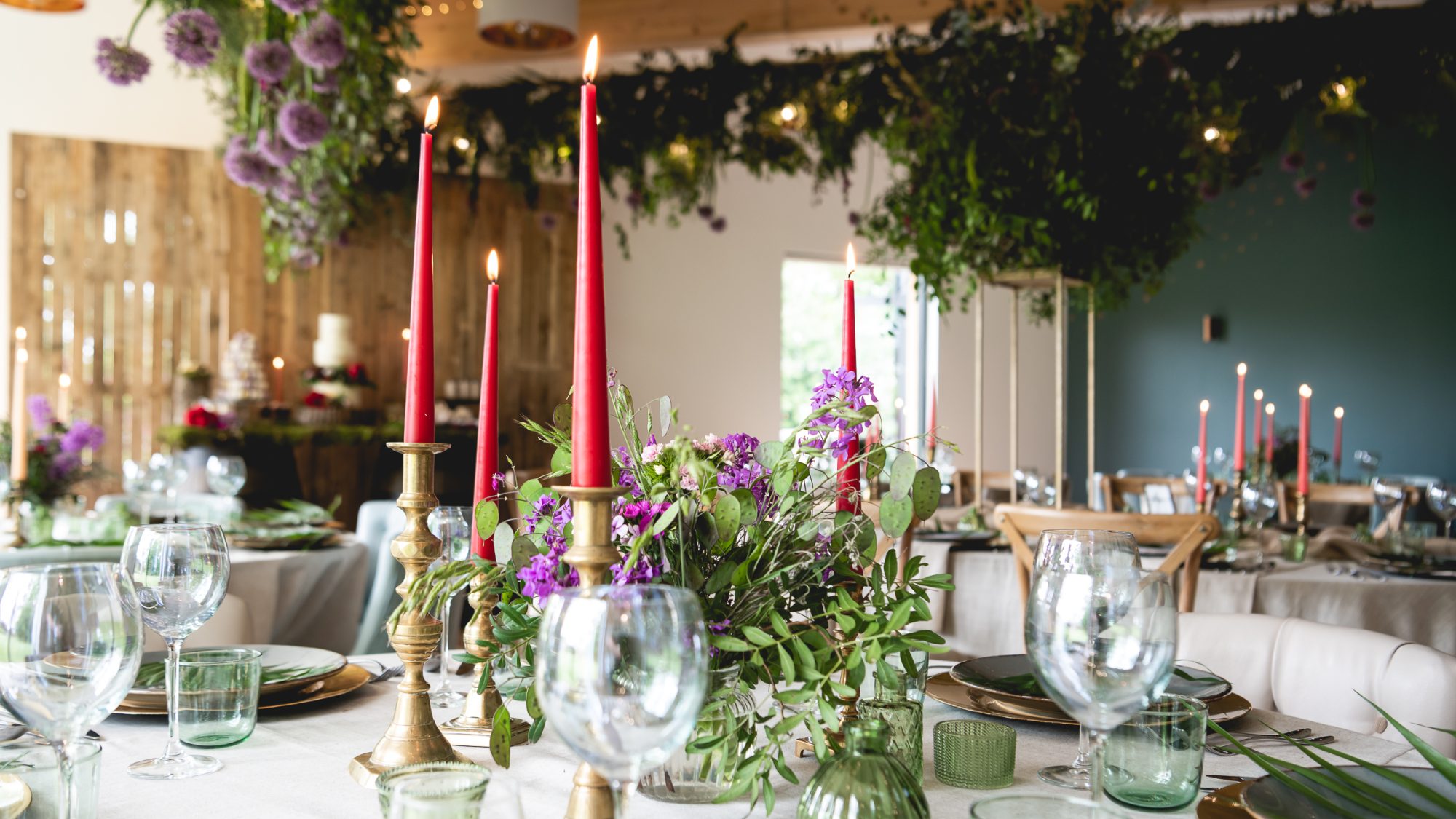 Flowers, glass-wear and candle sticks on decorated table