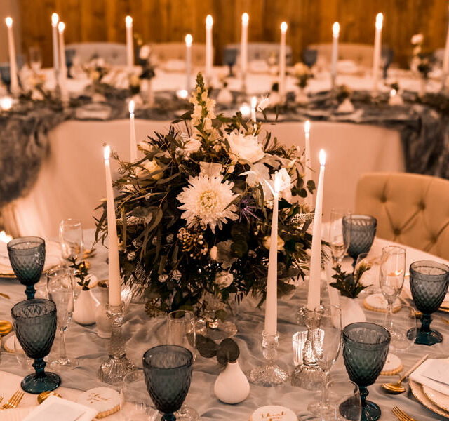 Round table with flowers and candles in wedding venue